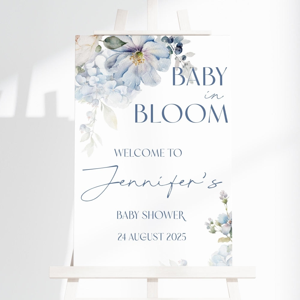 Baby shower sign with floral design and text on a white background