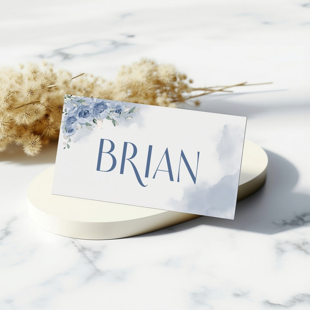 Place card with 'BRIAN' on a marble surface with dried flowers