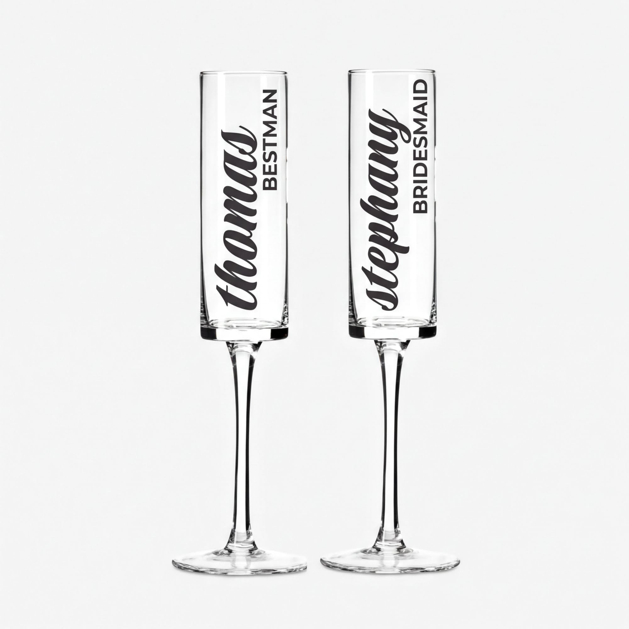 Two clear glass goblets with personalized names printed on them.