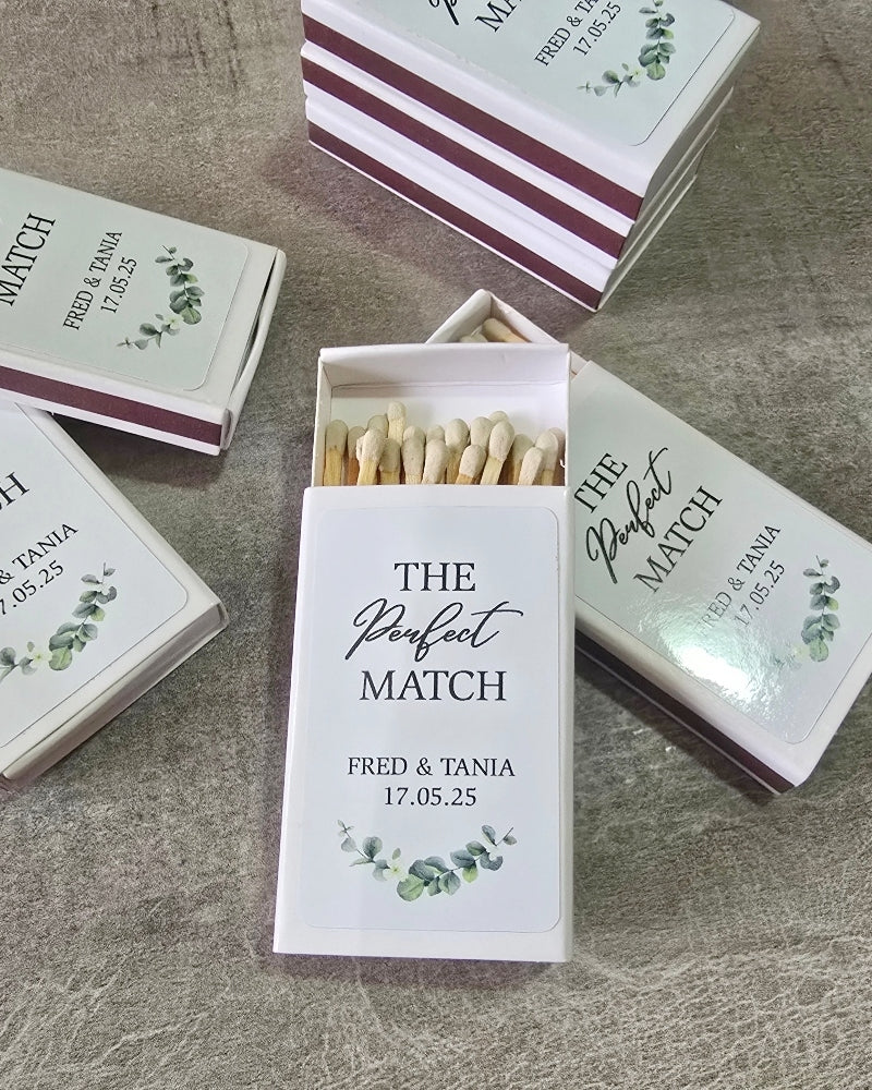 Matches boxes labelled 'The Perfect Match' with personalized text on a textured surface