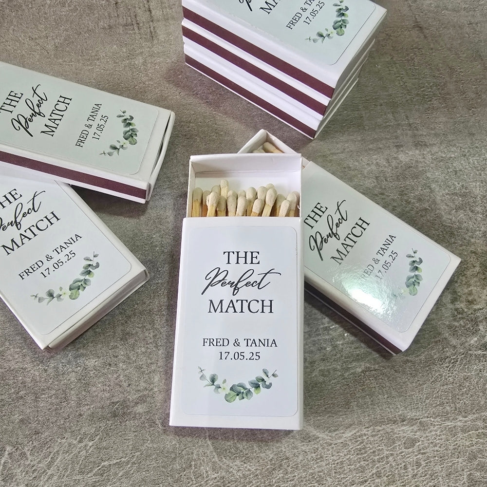 Matches boxes labelled 'The Perfect Match' with personalized text on a textured surface