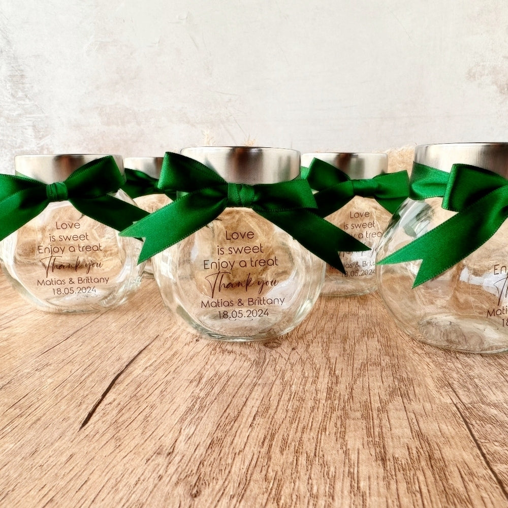 small glass candy jar with personalised sticker and ribbon