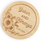 A wooden coaster with a floral design and text that reads "Gabor and Kerena" and "25.04.2026".