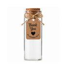 Clear glass jar with a cork lid and 'Thank You' tag on a white background