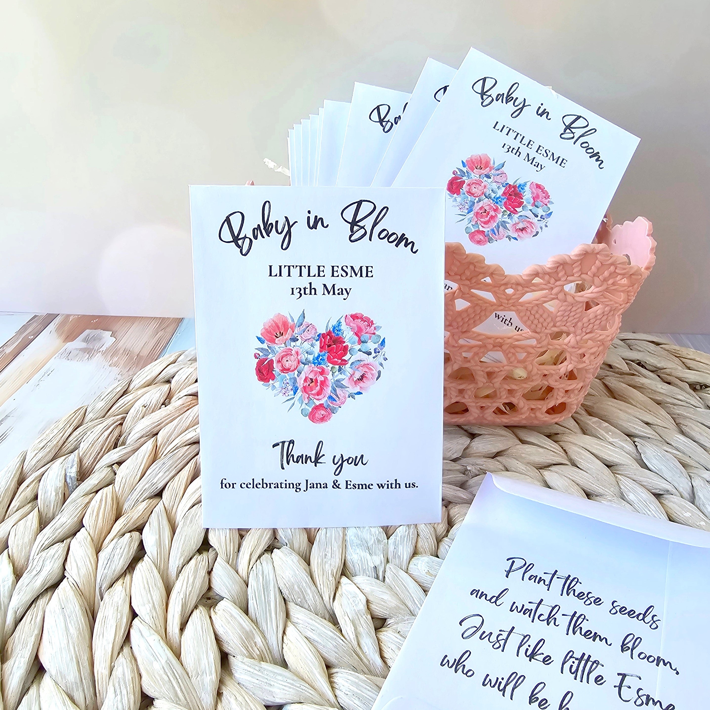 Baby shower thank you seed pack favours with floral designs on a woven surface
