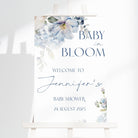 Baby shower sign with floral design and text on a white background