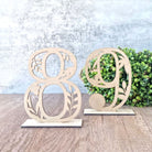 Numerical table number with intricate leaf design
