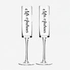 Two clear glass goblets with the names "Mr. Andrews" and "Mrs. Andrews" printed on them in a vertical orientation.