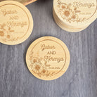 a collection of wooden coasters with floral designs and text engraved on them.