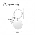 a silver keychain with measurements and a round tag attached to it.