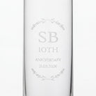 a clear glass with the text "SB 10th ANNIVERSARY 21.05.2026" engraved on it.