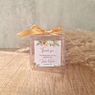transparent favour boxes with a custom sticker and ribbon