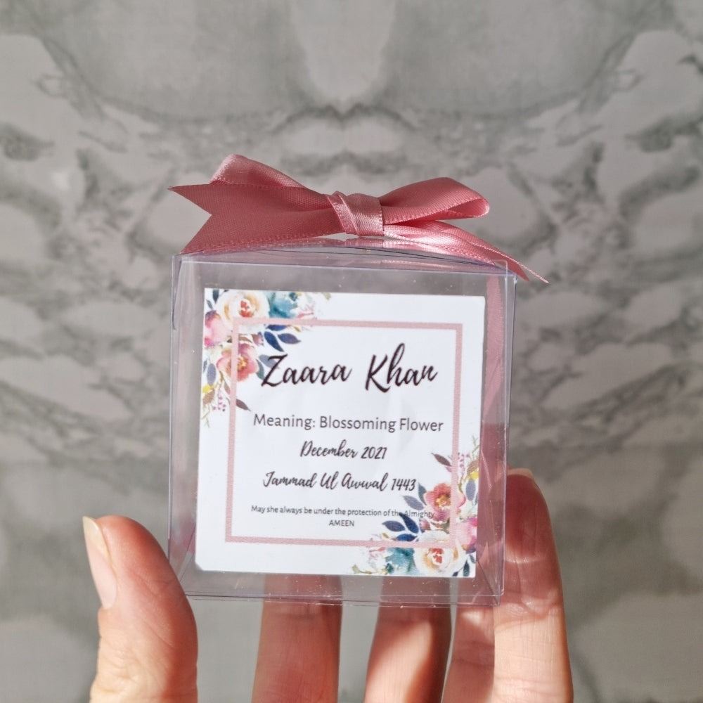 transparent favour boxes with a custom sticker and ribbon