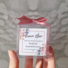 transparent favour boxes with a custom sticker and ribbon