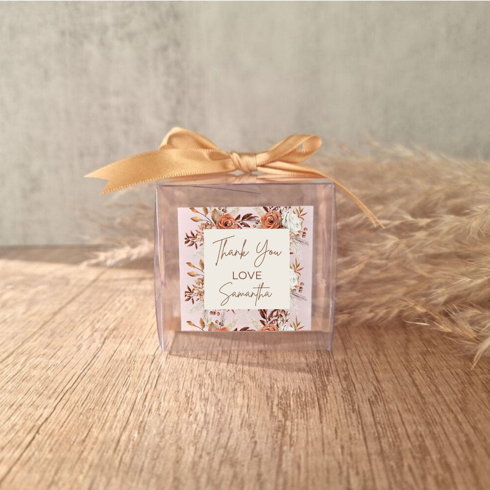 transparent favour boxes with a custom sticker and ribbon