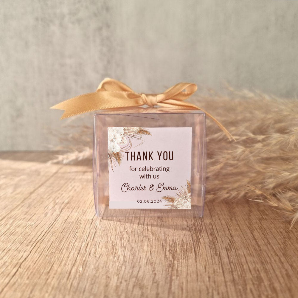 transparent favour boxes with a custom sticker and ribbon