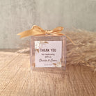 transparent favour boxes with a custom sticker and ribbon