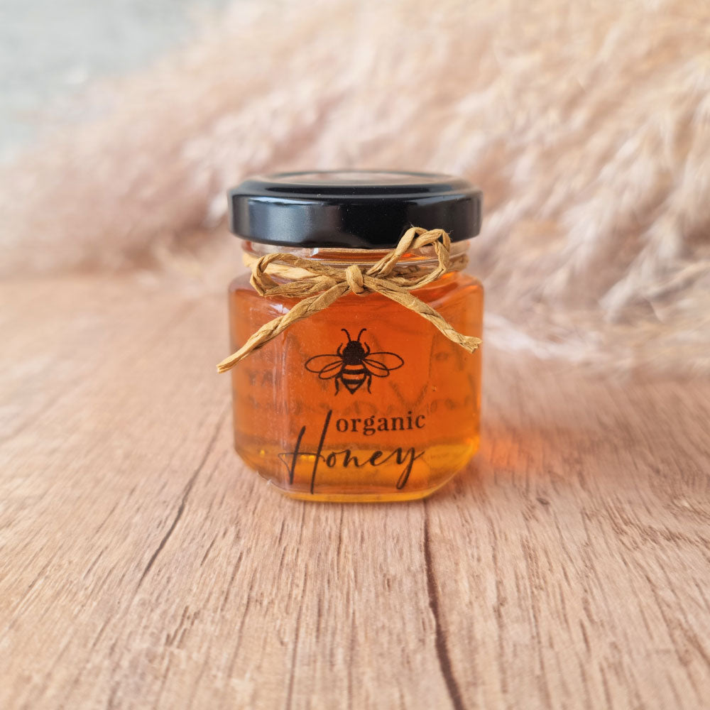 Honey in a hexagonal jar favour